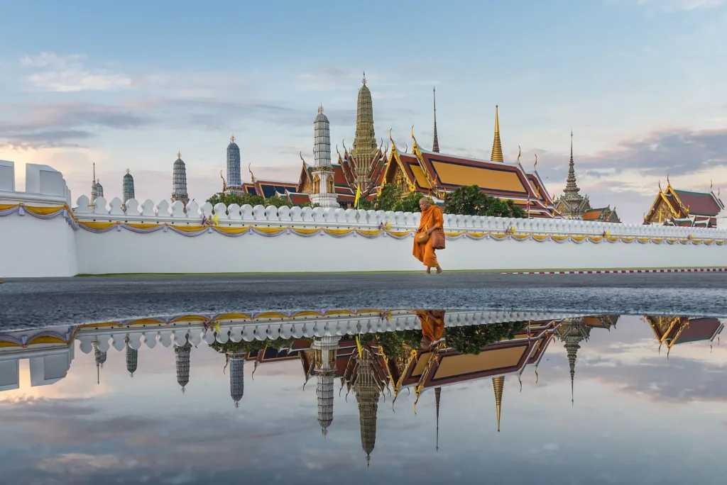 Wat Phra Kaew and the Grand Palace reflected in water in the morning