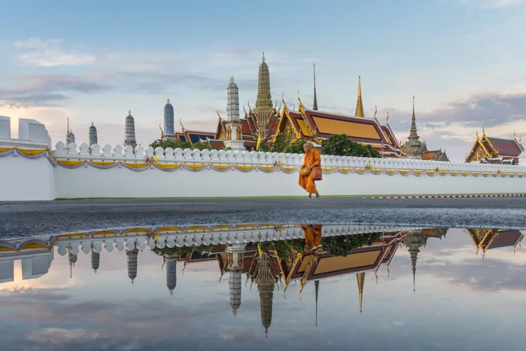 Wat Phra Kaew and the Grand Palace reflected in water in the morning
