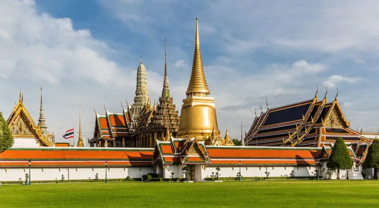 Temple buildings and the Phra Si Rattana Chedi seen from the Grand Palace lawn