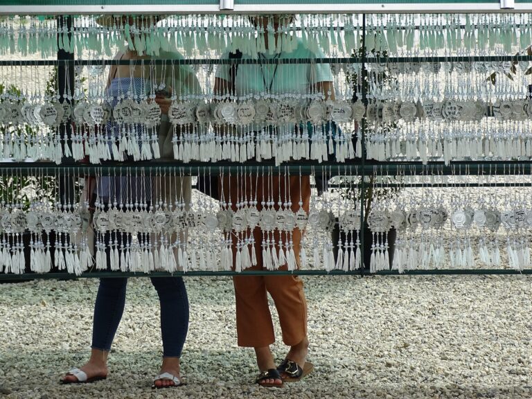 Metal wish plaques hanging in rows